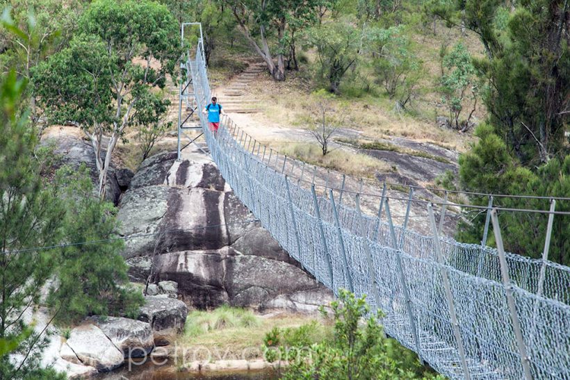 Some guy walking the bridge.