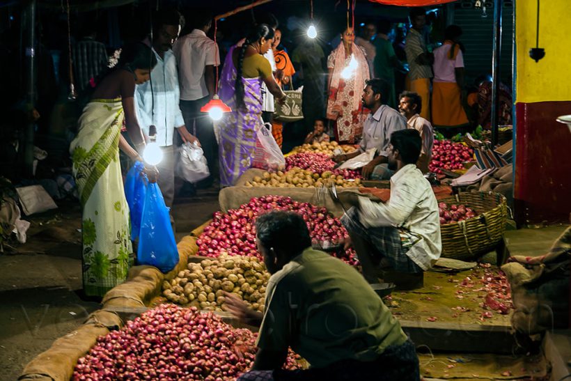 The local housewives haggling with the vegetable vendors.