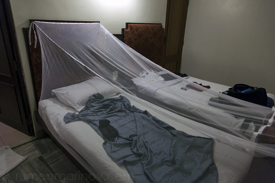 My room at Madurai Residency. I have stretched my mosquito net against mosquitoes and have prepared my special silk bed sheet against possible bed bugs. You can see the suspicious locked door on the other side of the bed.