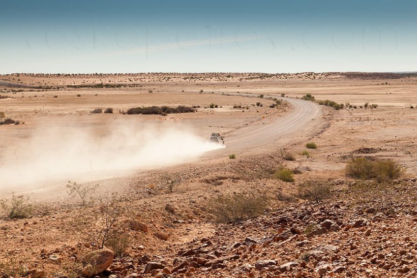 A rare vehicle passes me while I take a photo (and take a piss). You can see their dust from miles away.