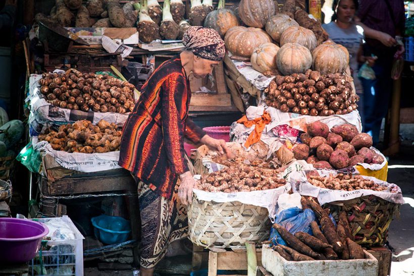 A grandma selling potatoes and other earth produce at Pasar Pabean.