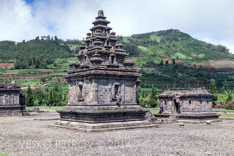 In a minute a couple of workers will climb on the smaller temple to clean the roof.