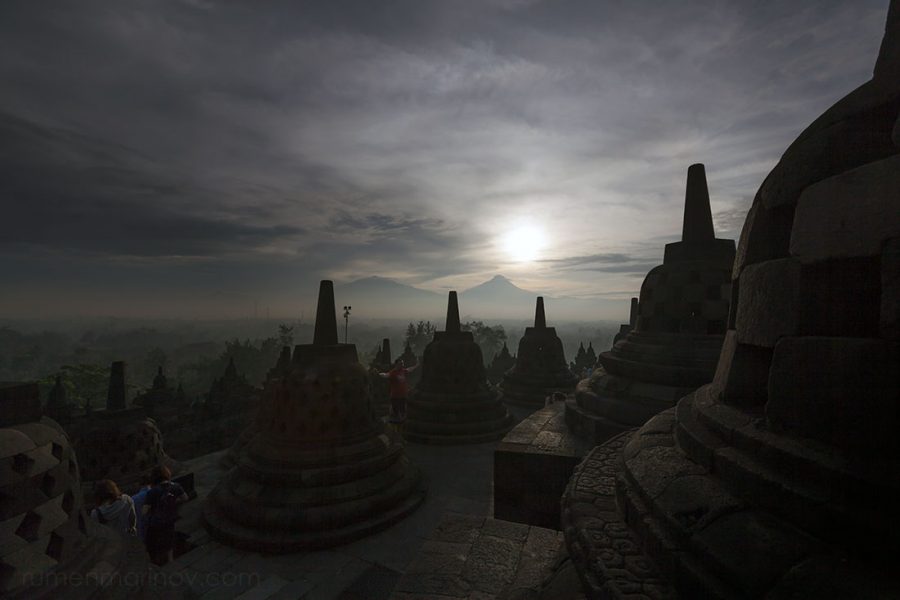 Sunrise at Borobudur Temple. The stupas are still in darkness due to heavy morning fog.