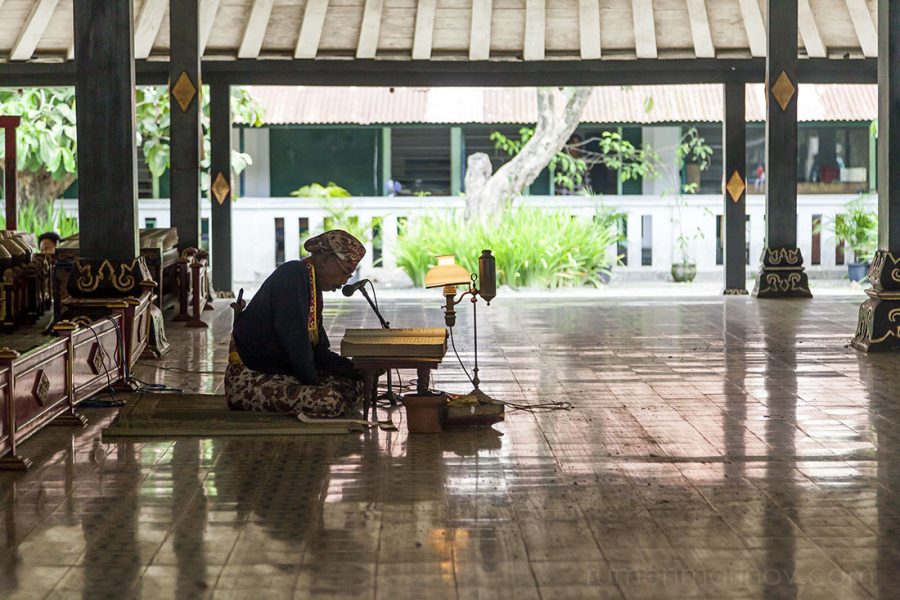 No, this is not the sultan waiting for the naked virgins, but a monk reading religious verses from the Quran.