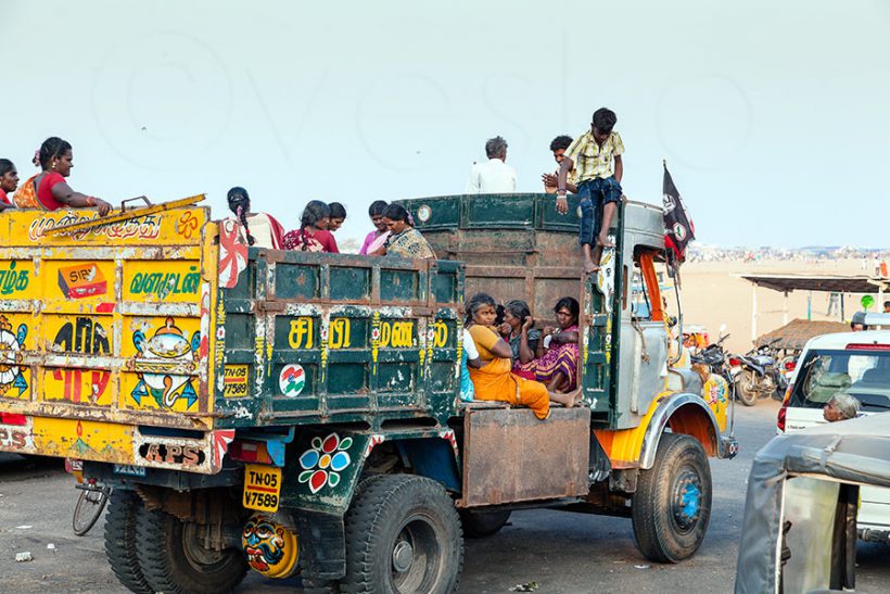 The people of a small community have hired a truck to visit the beach. Perhaps they celebrate Pongal, the harvest festival.